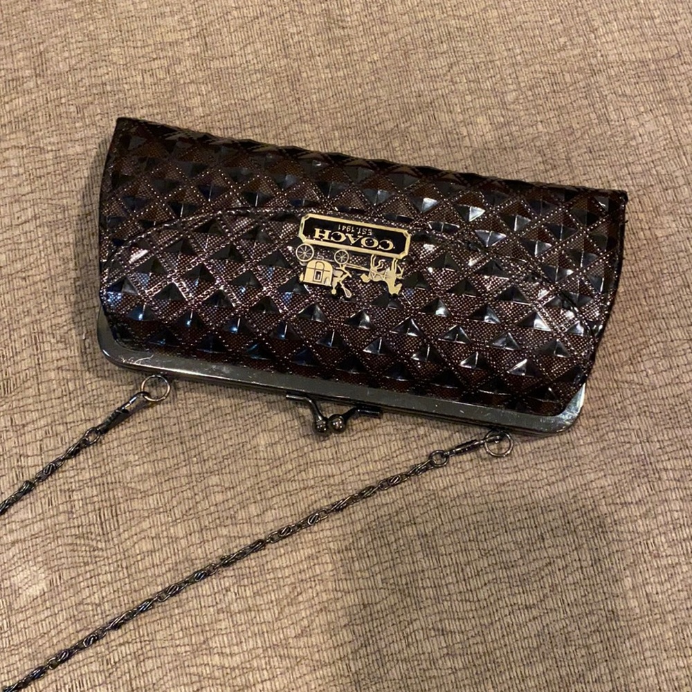 Purse with chain strap and decorative coach emblem